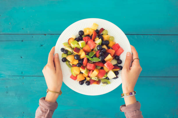 Mixed summer fruits salad top view