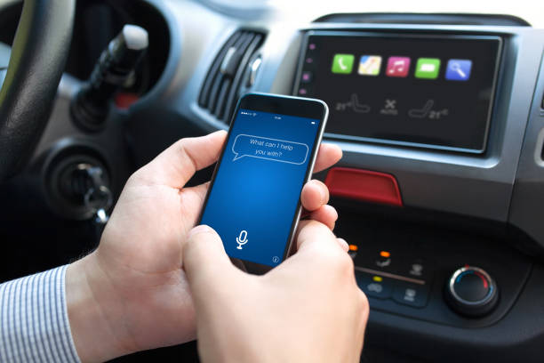 istock man hand in car holding phone with app personal assistant 1004021976