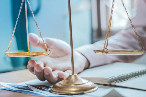 istock Concepts lawyer. businessman sitting holding scale law. Selective Focus 1004022268