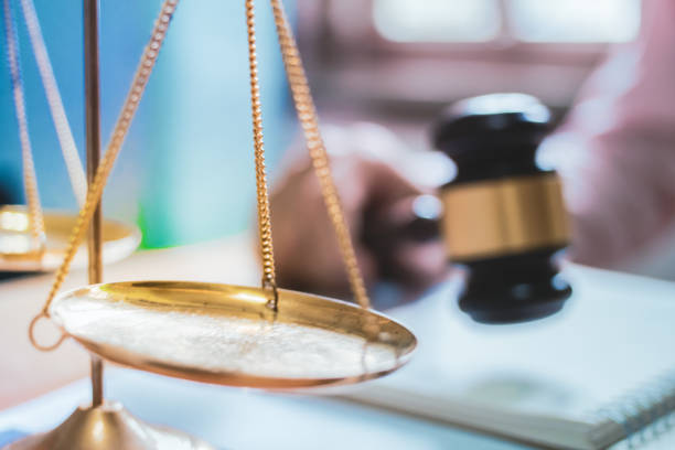 istock Holding Hammer law.Business man working on table. Lawyer Concepts .Selective Focus 1004022294