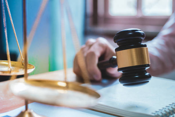 istock Holding Hammer law.Business man working on table. Lawyer Concepts .Selective Focus 1004022324
