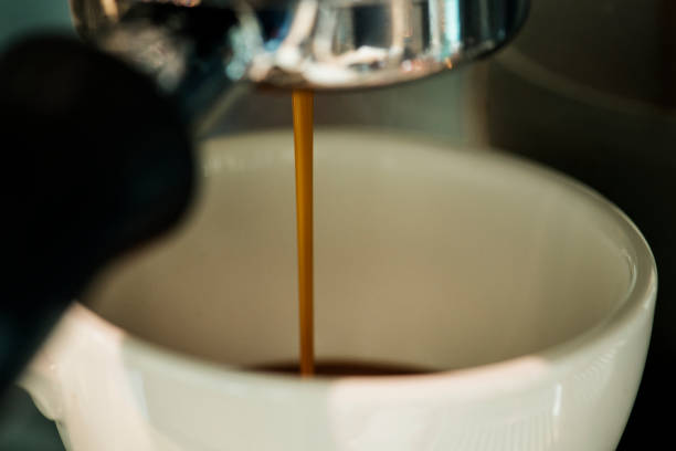 istock Closeup of coffee machine making espresso drink 1004025770