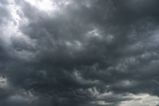 istock Dark, grim, stormy, rainy sky with rays of light. Scary hurricane clouds. Natural element. Stock Photo for your design 1004025986