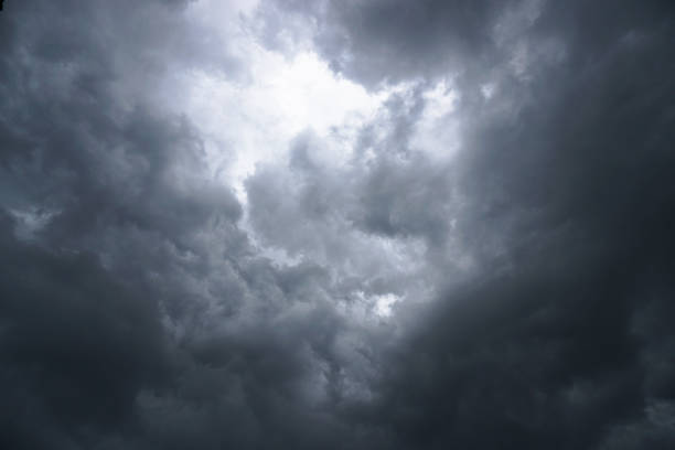istock Dark, grim, stormy, rainy sky with rays of light. Scary hurricane clouds. Natural element. Stock Photo for your design 1004026202