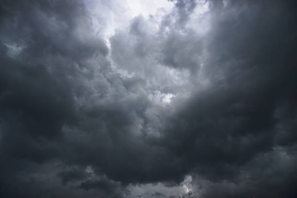 istock Dark, grim, stormy, rainy sky with rays of light. Scary hurricane clouds. Natural element. Stock Photo for your design 1004027038