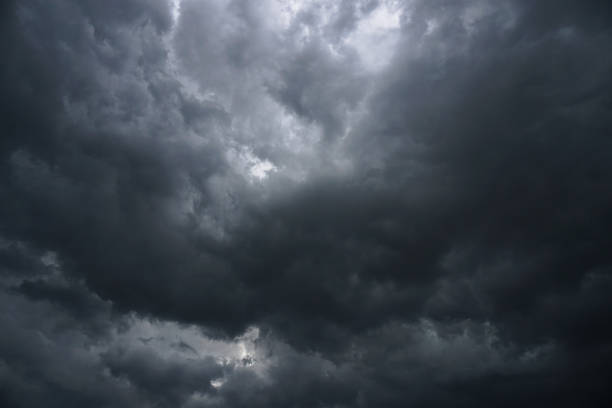 istock Dark, grim, stormy, rainy sky with rays of light. Scary hurricane clouds. Natural element. Stock Photo for your design 1004027044