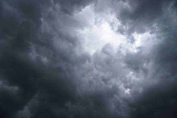 istock Dark, grim, stormy, rainy sky with rays of light. Scary hurricane clouds. Natural element. Stock Photo for your design 1004029178