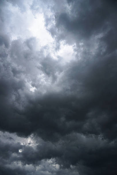 istock Dark, grim, stormy, rainy sky with rays of light. Scary hurricane clouds. Natural element. Stock Photo for your design 1004029698