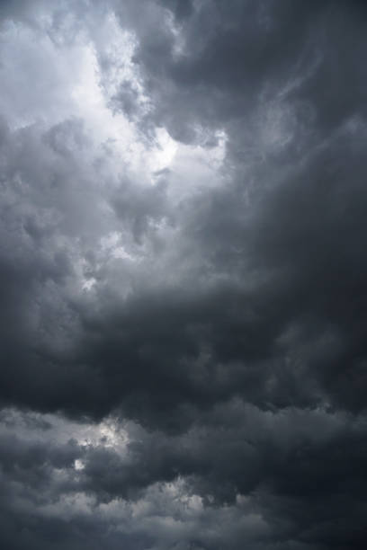 istock Dark, grim, stormy, rainy sky with rays of light. Scary hurricane clouds. Natural element. Stock Photo for your design 1004029972