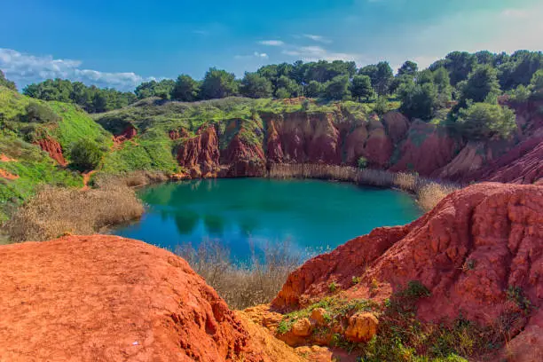 Salento, Otranto: lunar landscape of the lake of the bauxite quarry cave.