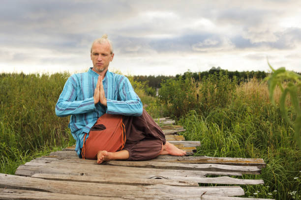 istock Handsome fit man doing yoga at the park 1004036204