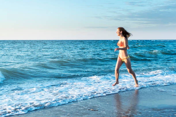 istock Woman running on the beach 1004036322