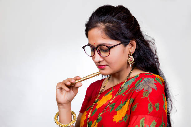 istock A young Indian woman in a thinking process holding a beautiful pen 1004036988