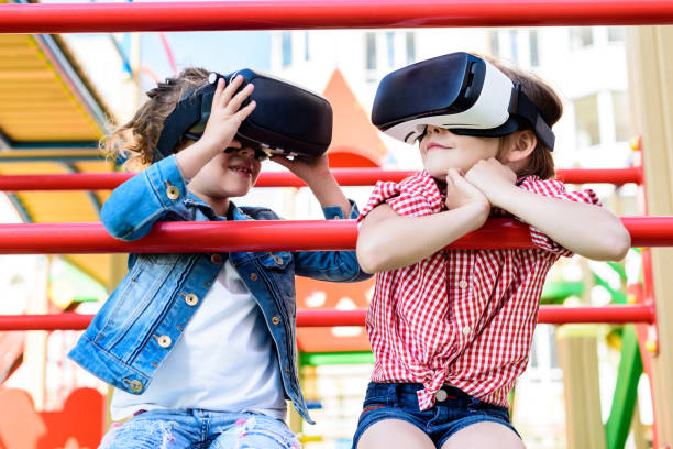 istock selective view of two little children using virtual reality headsets at playground 1004040884
