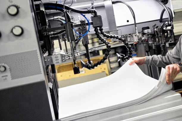 istock Cropped Hands Of Man Working In Printing Press 1004041704