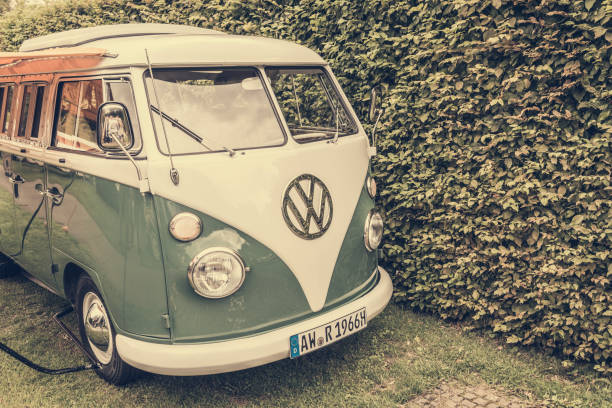 1950s Volkswagen Type 2 (T1) Transporter  Kombi or Microbus campervan with a sunblind parked in a park. The Volkswagen Transporter is a popular van to use as a camper and was delivered originally as a camper van, but many have been converted later. The car is on display during the 2017 Classic Days at Schloss Dyk in Juchen, Germany.