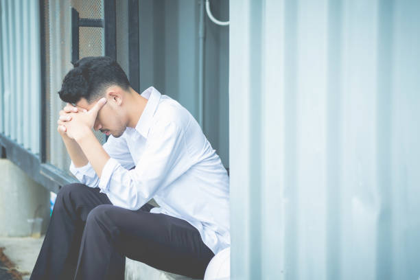 istock Tensed Man With Head In Hands Sitting Outdoors 1004048674