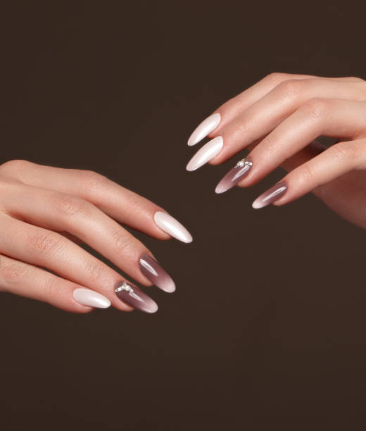 istock Beautiful classic manicure with crystals on female hand. Close-up. 1004049202