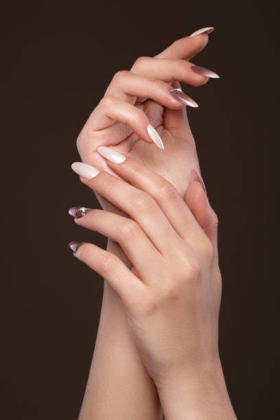 istock Beautiful classic manicure with crystals on female hand. Close-up. 1004049206
