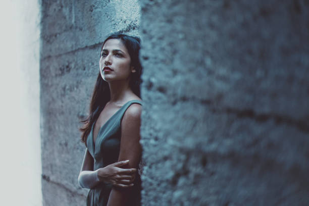 istock Pensive young woman leaning on the wall 1004049520