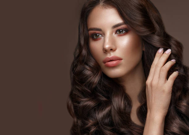 istock Beautiful brunette model: curls, classic makeup and full lips. The beauty face. 1004049668