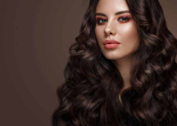 istock Beautiful brunette model: curls, classic makeup and full lips. The beauty face. 1004049816