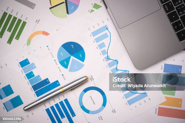 Business Documents On Office Table With Smart Phone And Digital Tablet And Graph Financial With Social Network Diagram And Computer Laptop On Wood Desk Stock Photo - Download Image Now