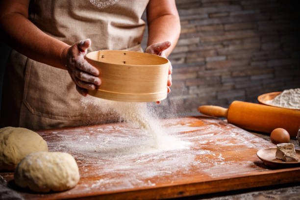 istock Woman hands sifting flour 1004056258