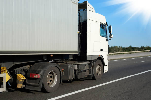 istock one truck with container on the road, side view with clear blank space 1004057758