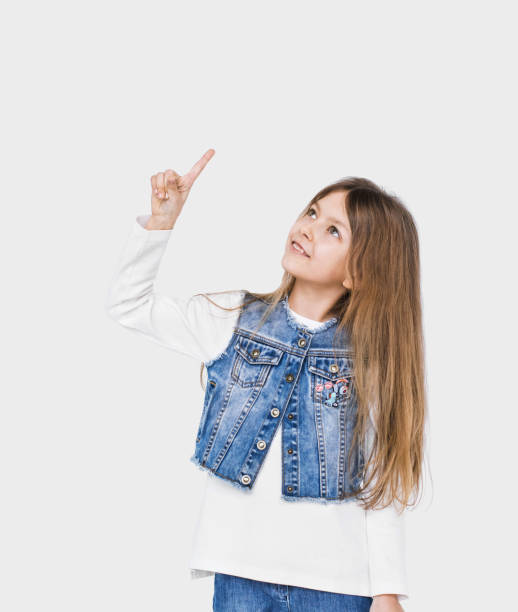 istock Cute little girl pointing up 1004078564