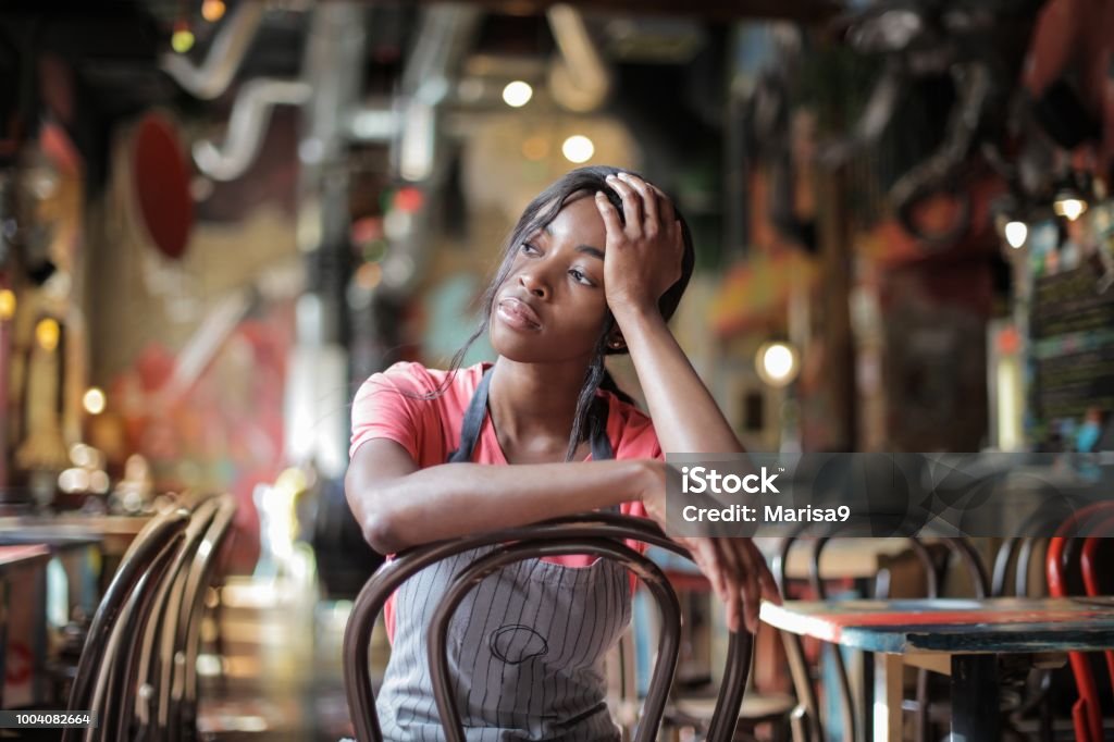 Tired bartender in a bar Tired Stock Photo