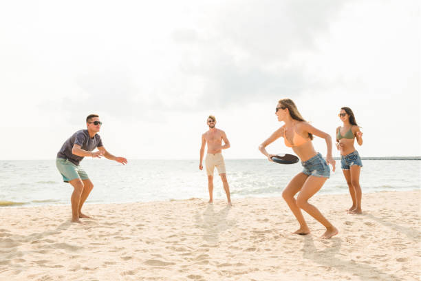 istock Group of friends playing at the beach on summer holidays 1004108372