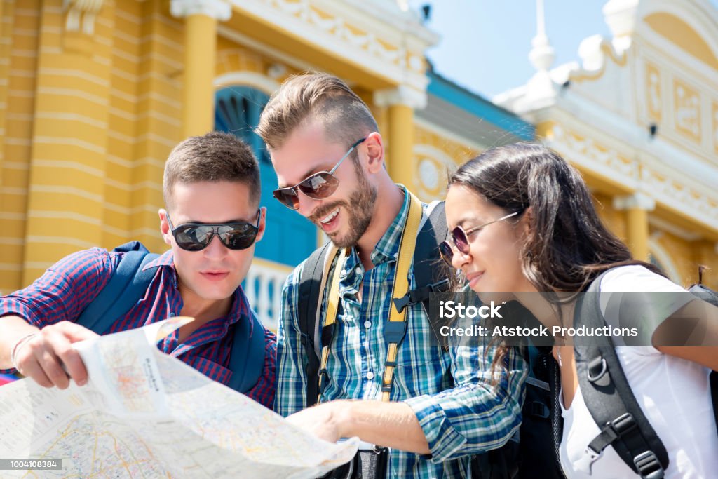 Group of tourist  friends looking for direction while traveling in Bangkok Thailand Group of tourist backpacker friends looking for direction while traveling in Bangkok Thailand on summer holidays Adult Stock Photo