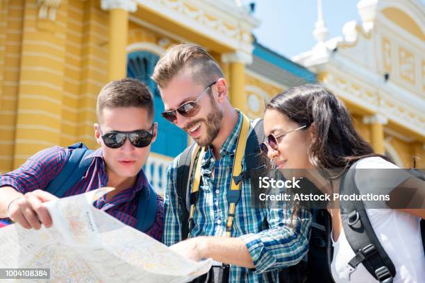 Group Of Tourist Friends Looking For Direction While Traveling In Bangkok Thailand Stock Photo - Download Image Now