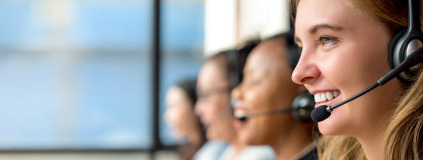 Woman customer service agents working in call center Friendly beautiful caucasian woman telemarketing customer service agent working in call center with multiethnic team global banner pictures stock pictures, royalty-free photos & images