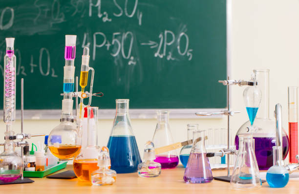 istock Glass flasks with multi-colored liquids at the chemistry lesson 1004111626