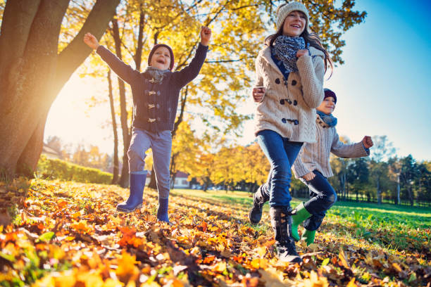 istock Kids running in park on autumn day 1004112078