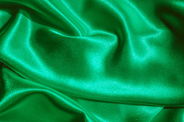 istock Texture, fabric, background. Abstract background of luxurious fabric or liquid waves or wavy grunge crease silk satin texture of velvet material or luxurious Christmas or elegant background. green 1004113142