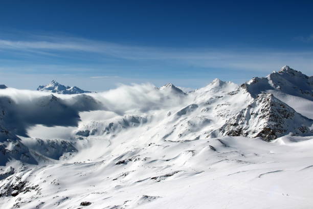 istock Snowy Mountains in the clouds blue sky Caucasus Elbrus 1004114122