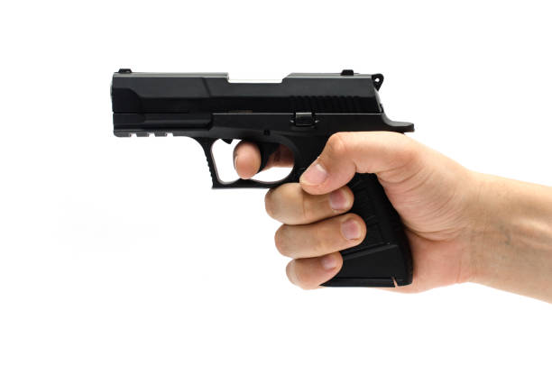 istock Gun, pistol in hand isolated on white 1004118350