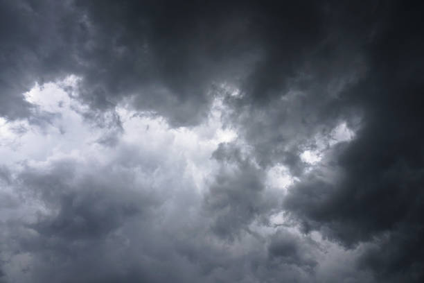 istock Dark, grim, stormy, rainy sky with rays of light. Scary hurricane clouds. Natural element. Stock Photo for your design 1004118528