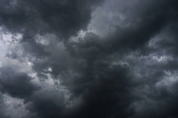 istock Dark, grim, stormy, rainy sky with rays of light. Scary hurricane clouds. Natural element. Stock Photo for your design 1004120814