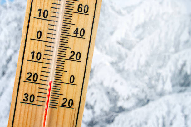 istock Detail of thermometer showing freezing 20 degrees Celsius sub zero, with blurred snow covered trees in background. Concept illustrating extreme cold weather. 1004121288