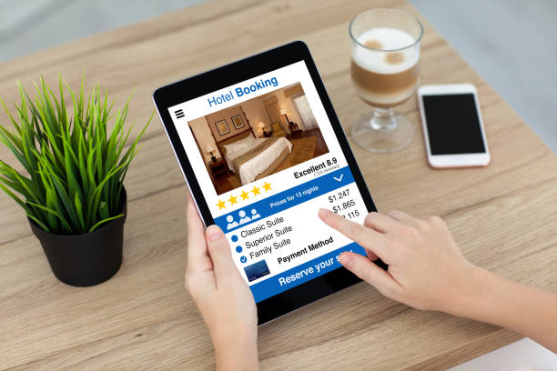 istock woman hand holding computer tablet with app hotel booking screen 1004121384