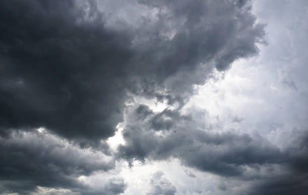 istock Dark, grim, stormy, rainy sky with rays of light. Scary hurricane clouds. Natural element. Stock Photo for your design 1004122396