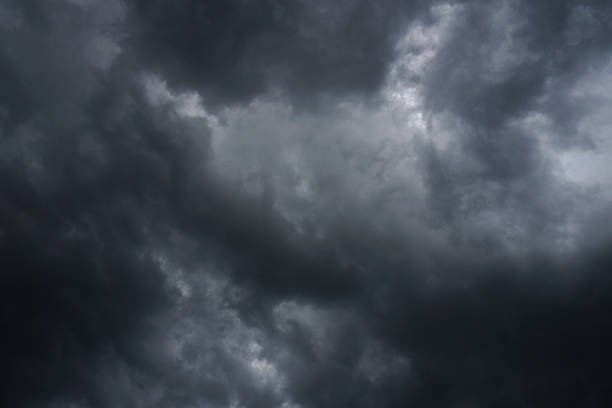 istock Dark, grim, stormy, rainy sky with rays of light. Scary hurricane clouds. Natural element. Stock Photo for your design 1004146510