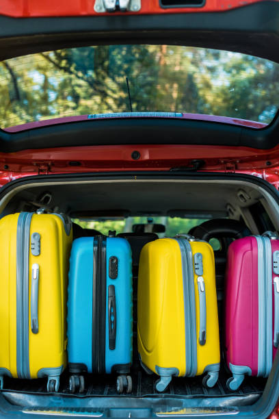 istock colored wheeled bags in car trunk 1004152192