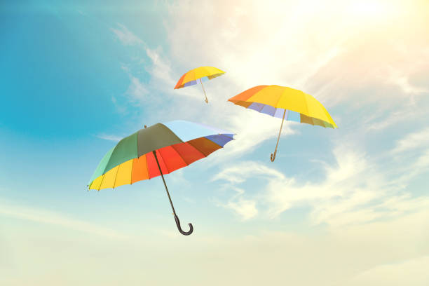 istock Colorful umbrellas floating against a beautiful sky 1004161284