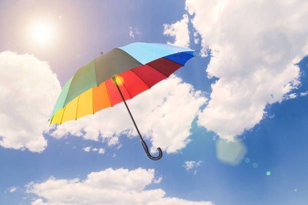 Red umbrella flying on a blue sky
