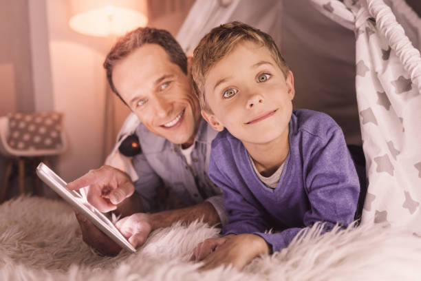 istock Positive cute boy being in the tent 1004184056